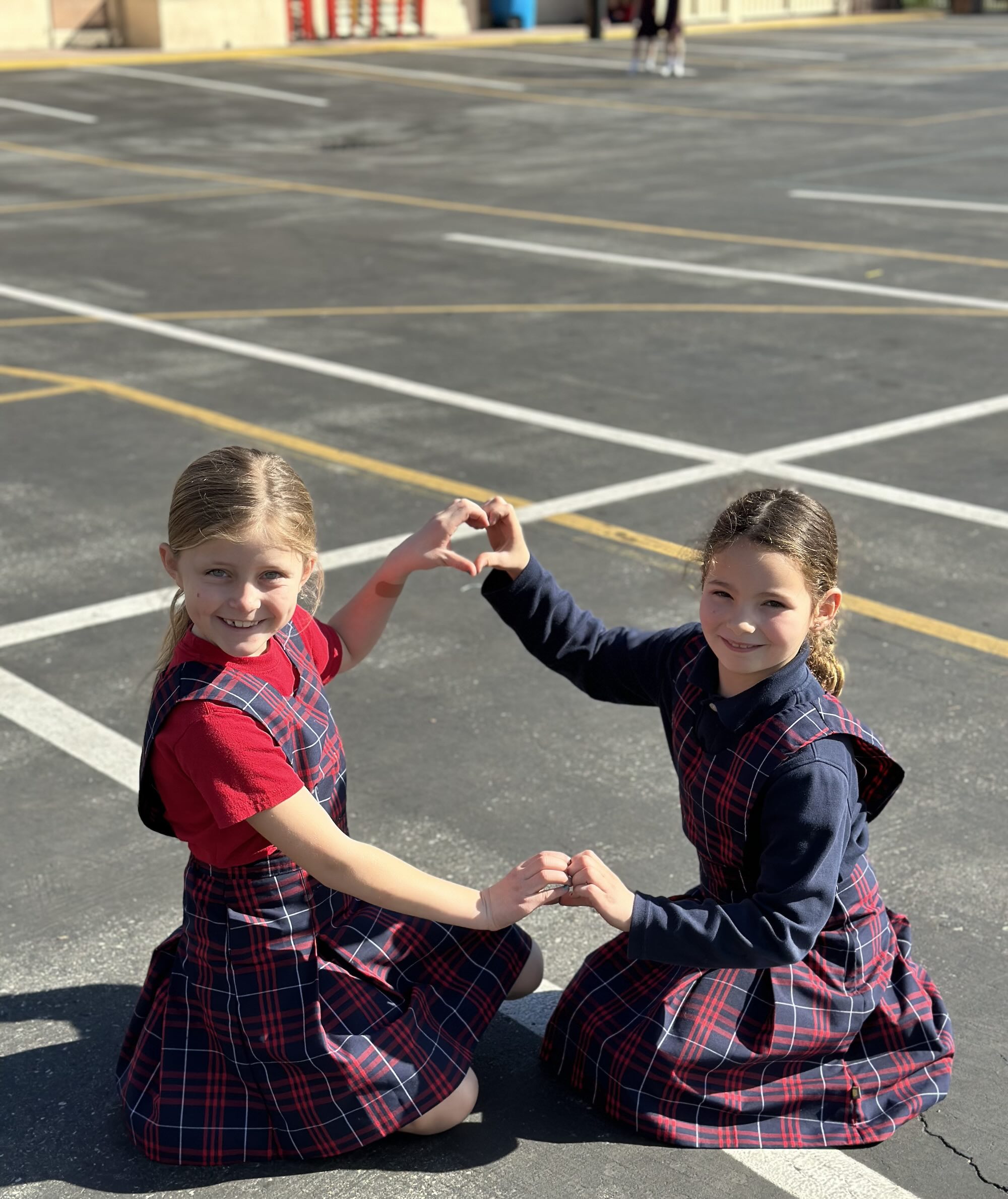 Two girls heart shape hands